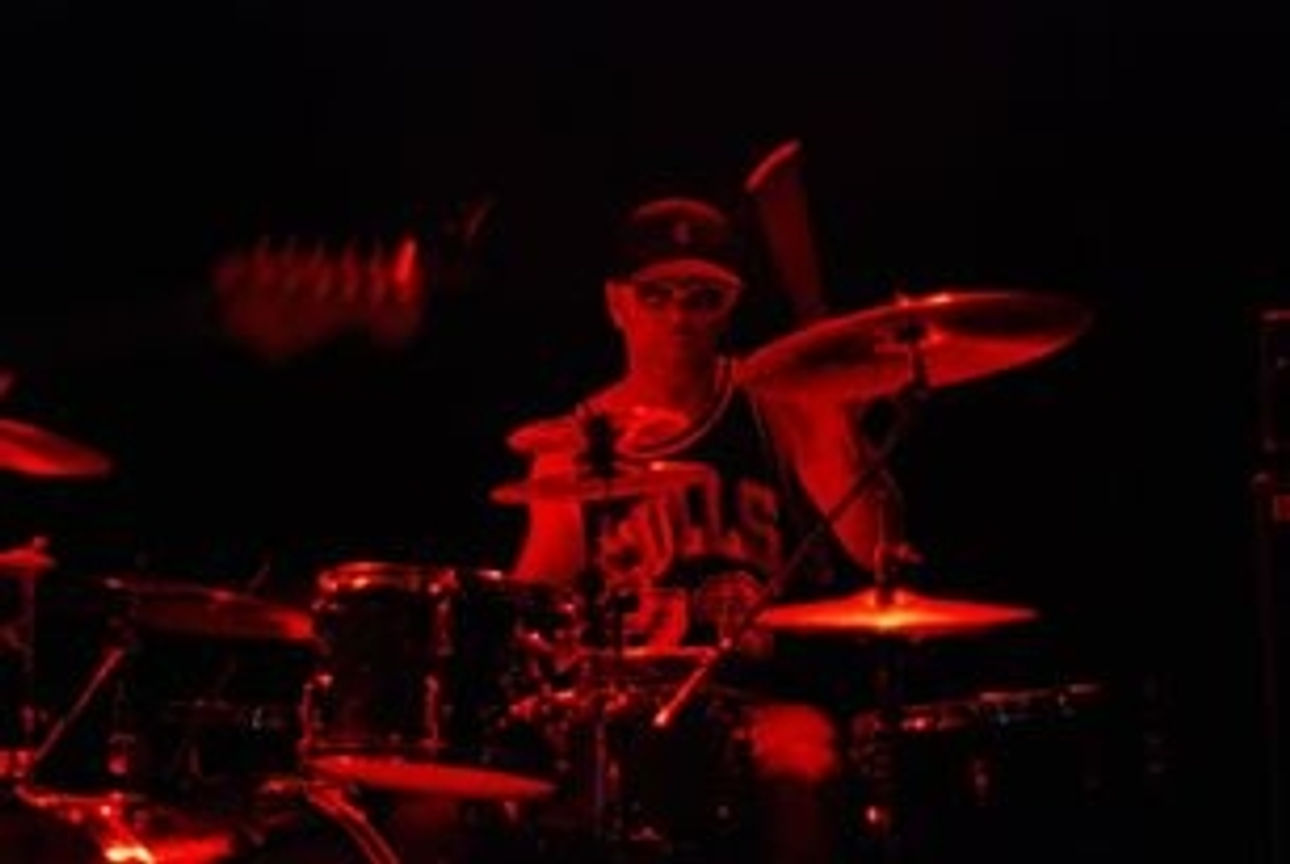 T Rex behind the drum kit